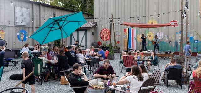 People sitting outside listening to music at Applefest held at Botanist and Barrel