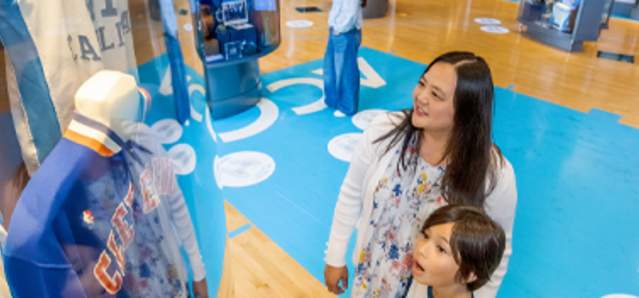 Fans looking at an exhibit at the Carolina Basketball museum