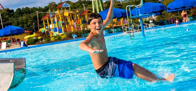 young boy having fun splashing around at a pool in Cincinnati