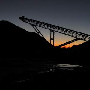 Mining equipment silhouetted against sky