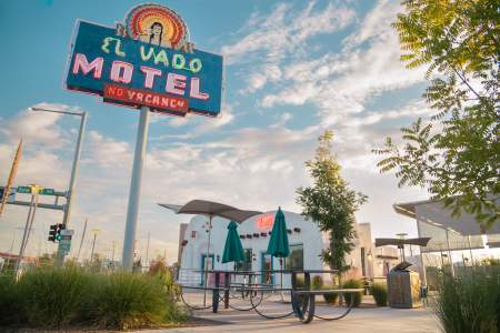 Looking up at the El Vado Motel's neon sign and the site's renovated plaza and office building.