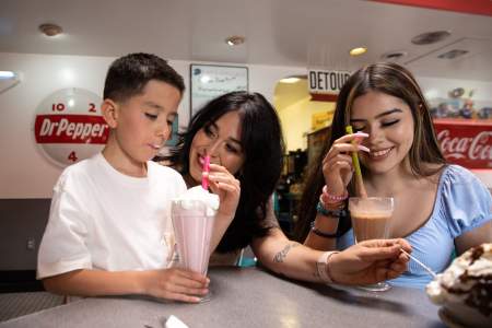three people drink shakes at Route 66 Diner
