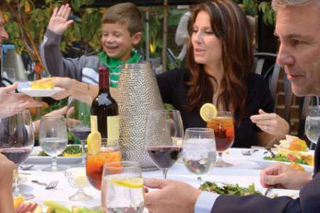 family of all ages sitting down to a formal dinner