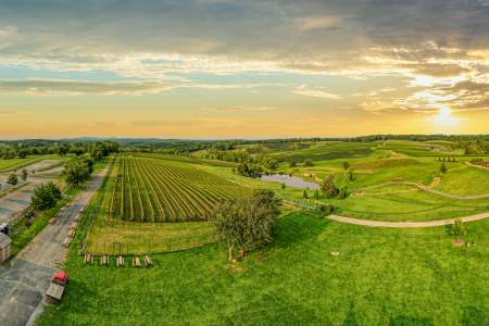 An aerial and panoramic view of Stone Tower Winery at sunset