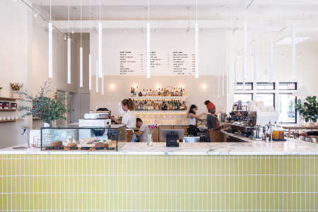 Baristas making drinks behind the marble counter at Goosecup coffee shop in downtown Leesburg Virginia