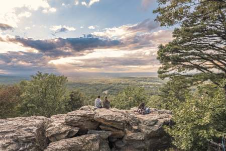 Visitors seated on a scenic overlook in Loudoun County with views of rolling countryside
