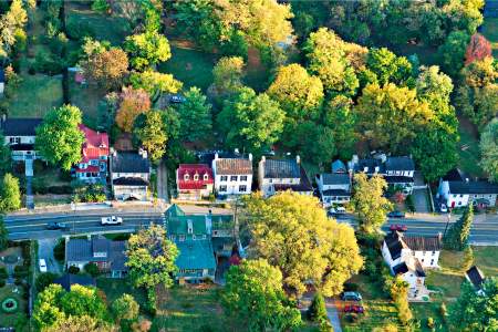 Aerial of Hillsboro, Virginia's tree-lined main street and historic homes amid fall foliage in western Loudoun
