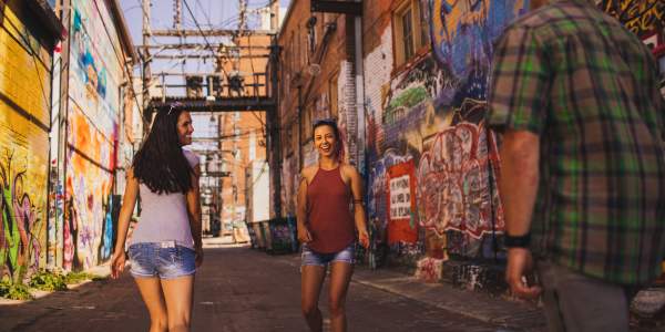 people walking through art alley in downtown rapid city, sd