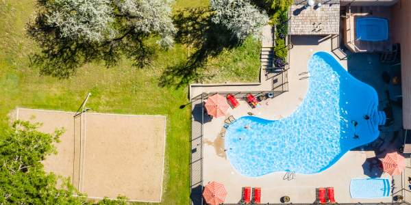 drone shot over the pool and sand volleyball court at the Rapid City KOA