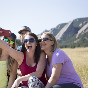 Group taking selfie in front of the Flatirons