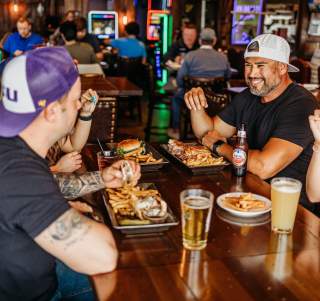 a Group eating at Niko's with beers and food