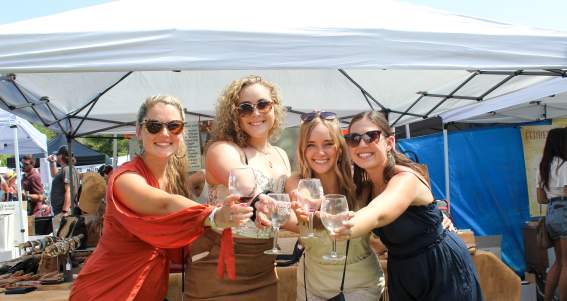 Group of women holding glasses of wine at Adirondack Wine and Food Festival