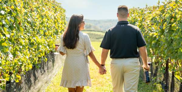 Couples Walk Through the Vines