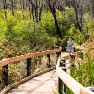 Girl walking along a boardwalk in the Yanchep National Park