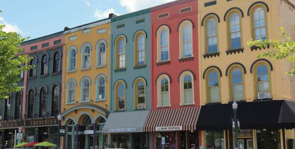 People walking by colorful buildings in Depot Town in Ypsilnati