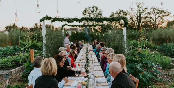Group having an outdoor dinner in a garden at Cornman