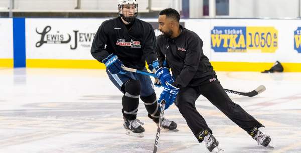 Hockey player and hockey coach on the ice