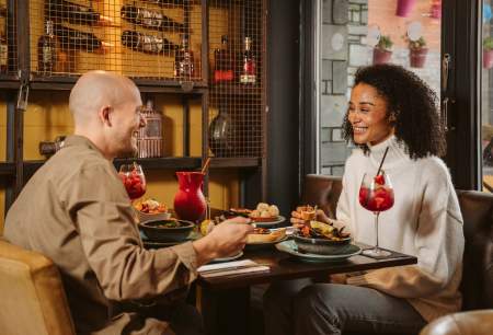 Couple enjoying evening meal and cocktails
