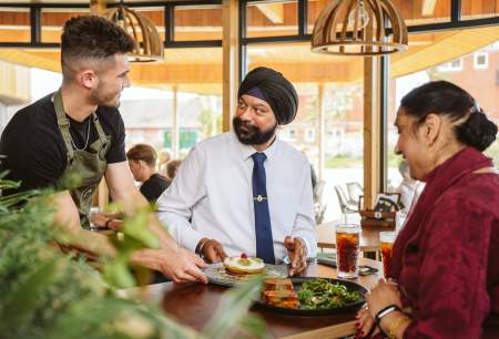waiter serving a couple their meal at the table