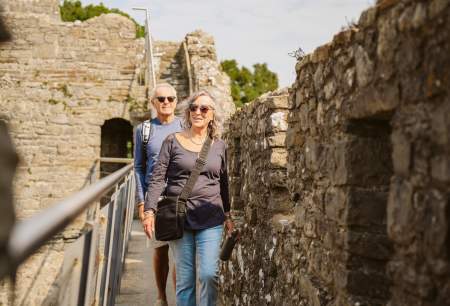 Couple walking along castle ramparts