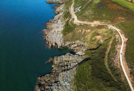 Gower coast path drone overlooking coastal path at cliffs seafront