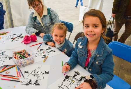Children colouring in on a craft table.