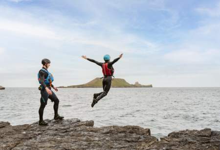Two people jumping into the sea