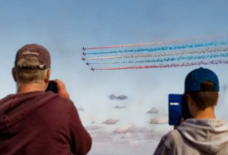 People taking photos of the red arrows at the Wales Airshow