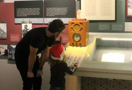 A child and father looking at an exhibit in the Dylan Thomas Centre.