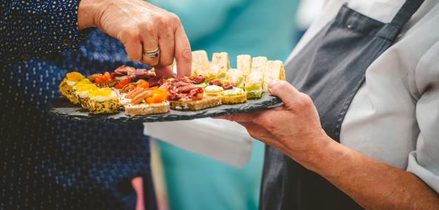 Image of someone picking up a food taster