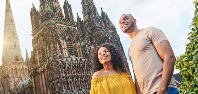 Couple outside Lichfield Cathedral on a sunny day
