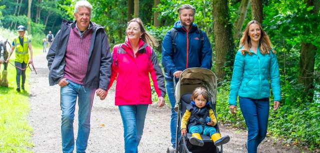 family with pushchair enjoy a country walk