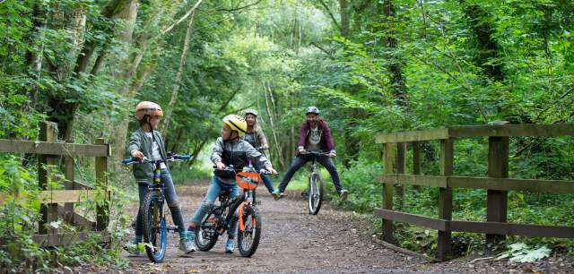 family cycling along Churnet Valley Way