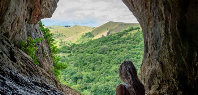 woman looking out from Thor's Cave