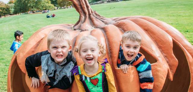 three kids in a pumpkin at Scarefest
