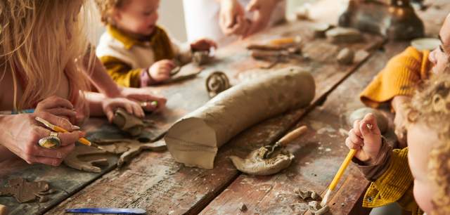 young visitors play with clay