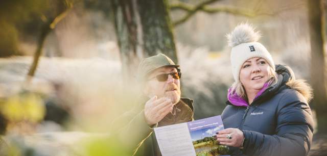 two  people  looking  at  leaflet