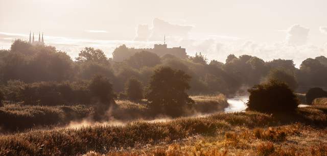 Scenic view mist rising from the river with Tamworth Castle in the distance