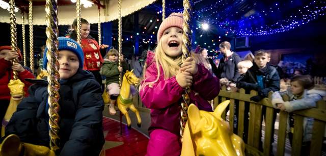 a girl on a carousel at Santa's Winter Wonderland