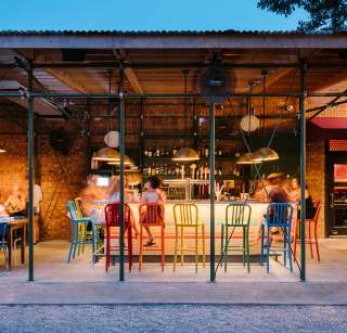 People dining at the colorful bar at Home Slice in Austin Texas