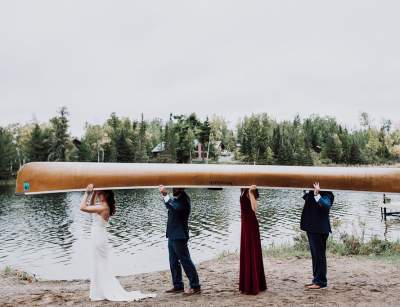 Wedding Party Carries a Canoe