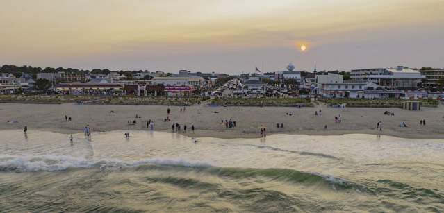 An aerial view of Rehoboth Beach and Rehoboth Beach Boardwalk at sunset.