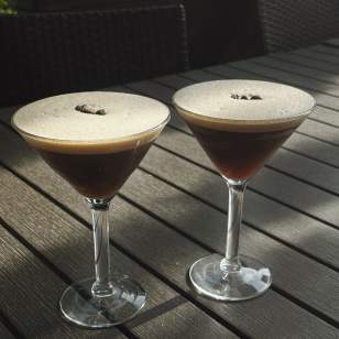 Two White Pumpkin espresso martinis with coffee bean garnish on a patio table at Z Cucina in Dublin, Ohio.