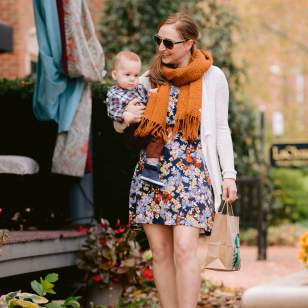 Woman carrying her baby down the leave covered streets in Historic Dublin