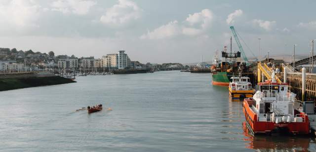 Newhaven Port, with fishing boats moored and a rowing boat on the river