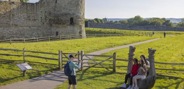 A group taking photos outside Pevensey Castle in Sussex