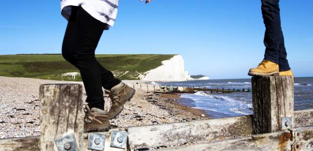 A couple of walkers on the beach at Birling Gap near Seven sisters in the South Downs National Park