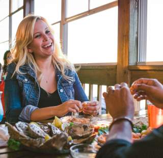 A couple eating seafood on an outdoor patio