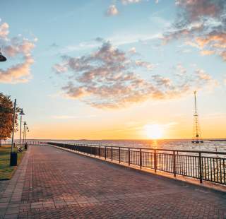 Scenic view of the James River with a bench in the foreground at sunset