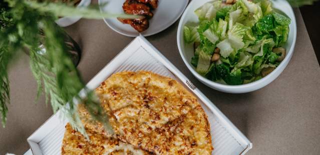 Pizza and salad on table